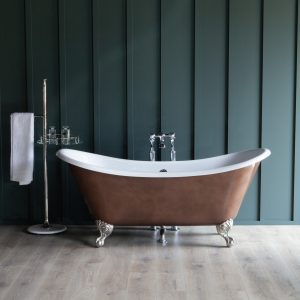 Elegant freestanding clawfoot bathtub with a copper exterior and chrome fixtures, set against a dark green paneled wall, showcasing luxury bathroom fixtures from The Albion Bath Co Ltd.