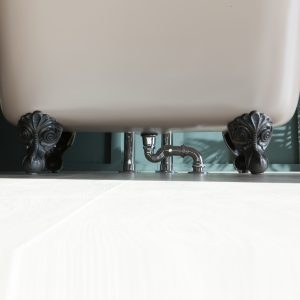 Ornate clawfoot bathtub with decorative black feet and modern plumbing, showcasing premium bathroom design and luxury bath fixtures from The Albion Bath Co Ltd.