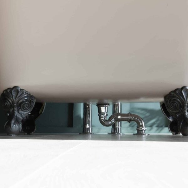 Elegant freestanding clawfoot bathtub with ornate black feet and chrome plumbing, showcasing luxury bathroom design from Albion Bath Co Ltd.