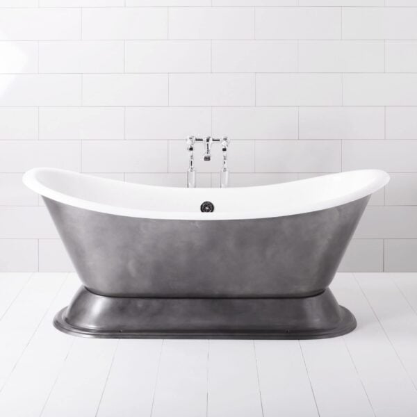 Cast iron vintage style freestanding bathtub with chrome taps in a modern minimalist bathroom setting, ideal for luxury bath experience and bathroom renovation.