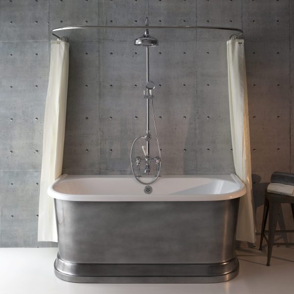 Sleek freestanding silver bathtub with vintage-inspired design, chrome fixtures, and minimalist shower setup against a modern concrete wall, perfect for luxury bathroom interiors.