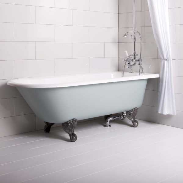 Cast iron clawfoot bathtub with vintage chrome fixtures in a modern bathroom setting, featuring white tiled walls and a minimalist aesthetic, ideal for luxurious bathing experiences.